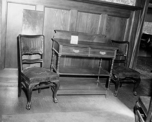 Two chairs by a sideboard