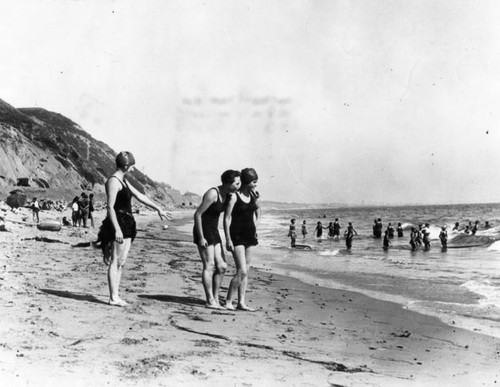 Three young ladies standing on the beach