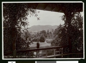 Exterior view of a Riverside residence, showing a city park in foreground, ca.1900