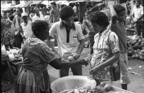 Woman selling fruits at a market, Cartagena Province, 1975