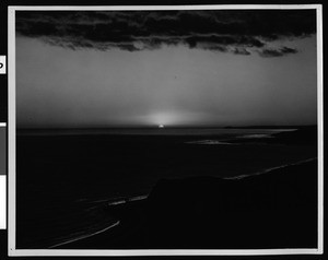 View from cliff top, looking down Malibu coastal area at sunset, ca.1935