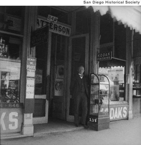 Francis E. Patterson standing at the entrance to his photography store at 846 Fifth Avenue