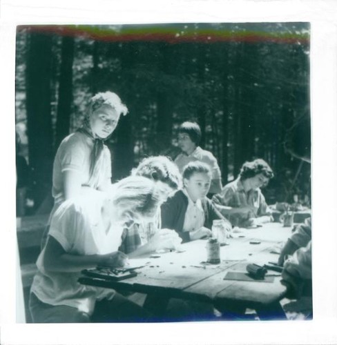 Teenage girls working on a project at a picnic table