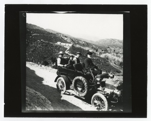 Men driving on mountain road