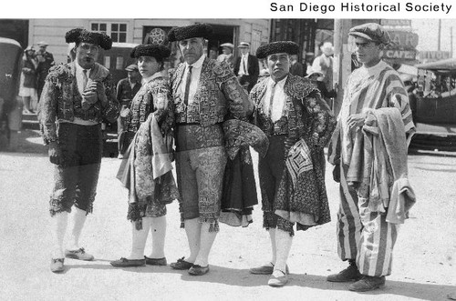 Four bullfighters and a man wearing a striped jumpsuit in Tijuana, Mexico