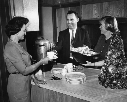 Mrs. Ruth Neve, left, starts program with cup of coffee