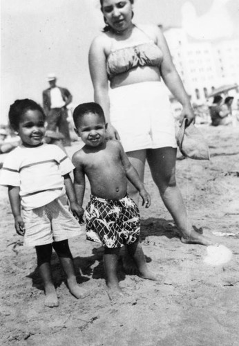Woman on beach with children