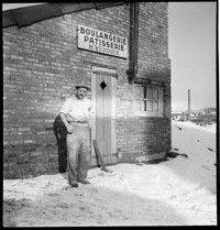 Lisieux [Bakery: man outisde Boulangerie / Patisserie H. Verdier, in snow.]