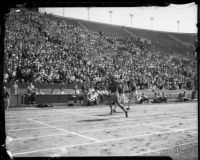 Jesse Owens competes in a race against USC track members at the Coliseum, Los Angeles, 1935