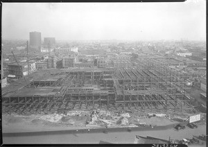 Birdseye view of the partially completed City Hall building in Los Angeles from a building in the civic center, 1926-1928