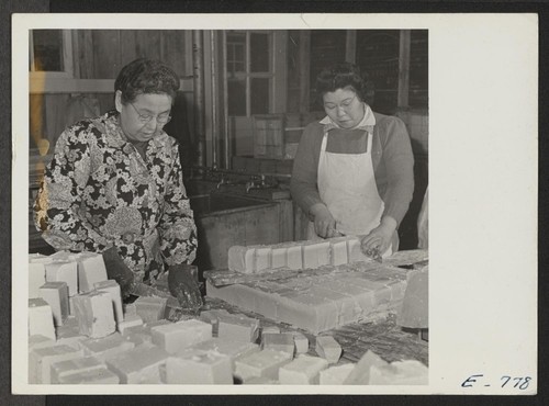 In a makeshift soap factory, at the Jerome Center, Mrs. K. Oyama and Miyo Mishikawa cut bars into hand sizes