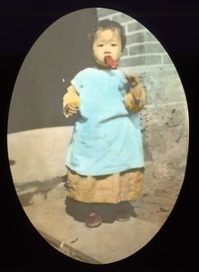 Young girl eating, China, ca. 1918-1938