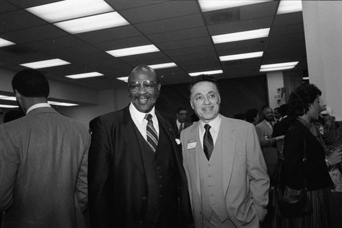 Elbert T. Hudson posing with an unidentified man at his father's 98th birthday celebration, Los Angeles, 1984