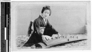 Young Japanese woman playing a koto, Japan, ca. 1911