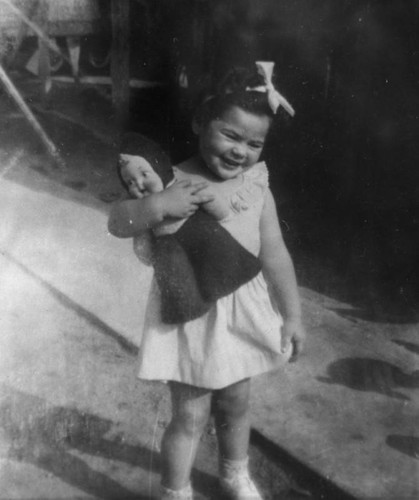 Mexican American girl with doll