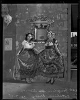 Josephine Gomez and Catalina Cruz where traditional Mexican costumes at a shrine dedicated to Sien Fa in China City, Los Angeles, 1938