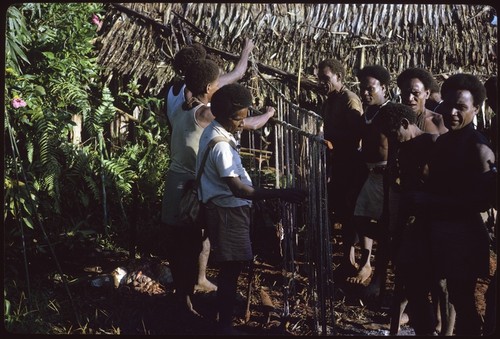 Group of men around a shell money payment, probably a bride price wa'i payment