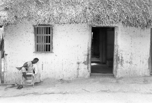 Man sitting near a doorway, San Basilio de Palenque, 1977