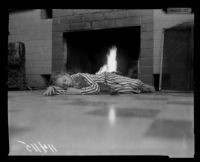Survivor of Fountain of the World headquarters bombing Jesse Vezina sleeps with her cat in front of the fireplace, 1958