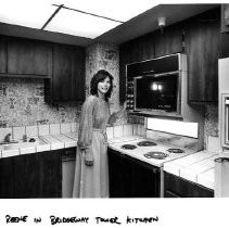 Reene showing kitchen inside Riverfront Plaza condominiums