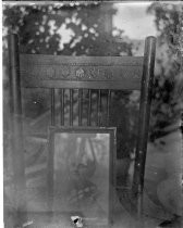 Chair holding framed portrait of a woman, c. 1912
