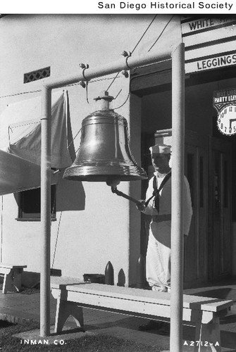 A sailor ringing a ship's bell at a San Diego navy base