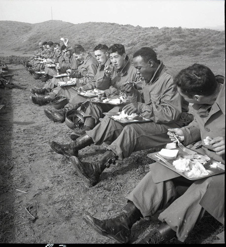 Trainees eating lunch in the field at Fort Ord