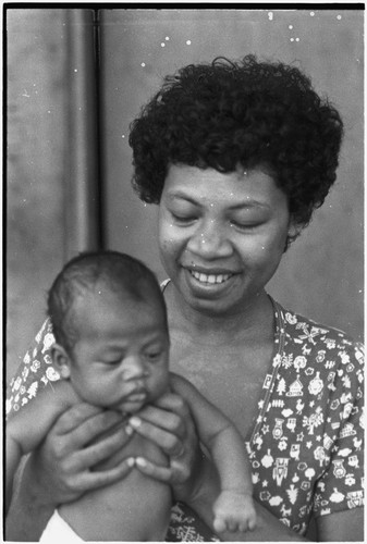 Family scene: woman holding young infant