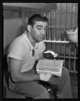 Seymour Schindell, accused of punching Miss Lee, sitting in his cell at the Hollywood police station, Los Angeles, 1935