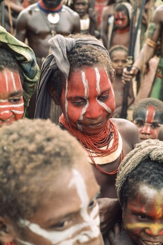 Girls decorated for a ceremonial, red and white face paint, pearlshell and trade beads