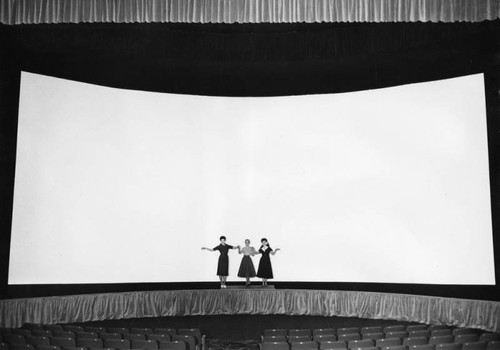 Three women on a bare stage