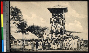 People gathered before and on a tall wooden tower, Congo, ca.1920-1940