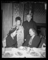 Catholic Woman's Club members Mrs. J. Selby Spurck, Elizabeth Guttenberg, Mrs. Yi-Seng Kiang and Reverend Joseph T. McGucken Los Angeles, Calif., 1948
