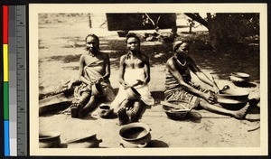 Three female potters working outdoors, Congo, ca.1920-1940