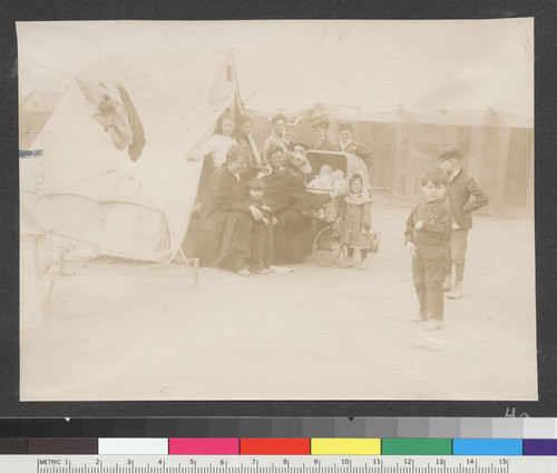 [Group of refugees at tent. Unidentified camp.]