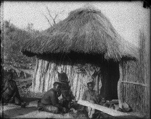 African people sitting in front of a hut, Shilouvane, South Africa