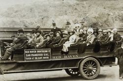 Raymond family and others seated in a Red Raven Sightseeing Co. Model 88-8 touring car, San Francisco, California, about 1912