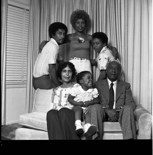 Adam Burton II and his family posing for a group portrait, Los Angeles