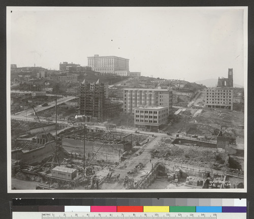 [View of Nob Hill up Stockton St. during reconstruction. Temple Emanu-el in scaffolding on Sutter St., center; Fairmont Hotel atop hill; Grace Church, right.]