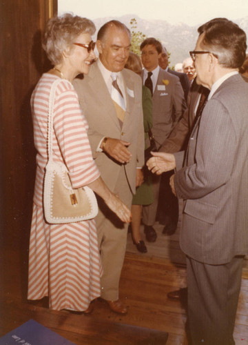 Justice Harry A. Blackmun speaking to two guests (Color)