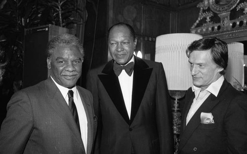 Mayors Harold Washington and Tom Bradley posing together with Hugh Hefner, Los Angeles, 1983