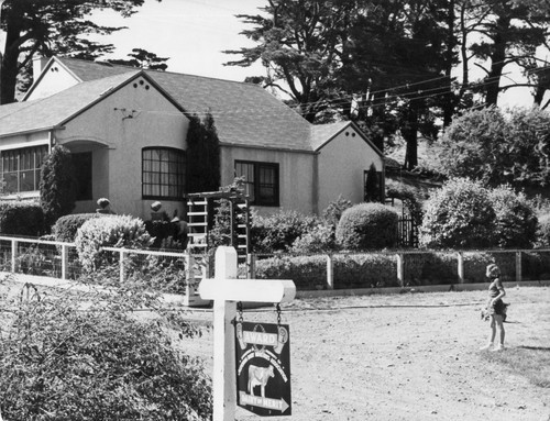 03 Here is where Mr. Hopkins and his family live. They have the Dairy of Merit Plaque in front of their house. This Plaque was awarded to them by the California Dairy Industries Association. It shows that Mr. Hopkins and his family are proud of their home and dairy because they have met the Association's high standards for neat and attractive appearing buildings and grounds