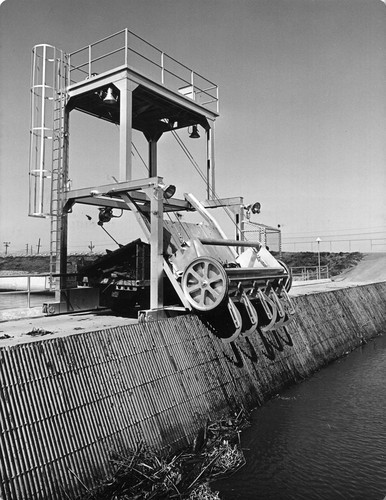 34 This is a trash rake located at the beginning of the intake canal. It is used to remove trash from the canal and to keep the canal operation clean. The rake lowers 25 feet from the road level to the bottom of the canal and moves horizontally 100 feet in its operation