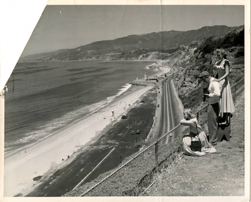 Publicity photo of tourists overlooking Roosevelt Highway and the coast towards Malibu, 1940s