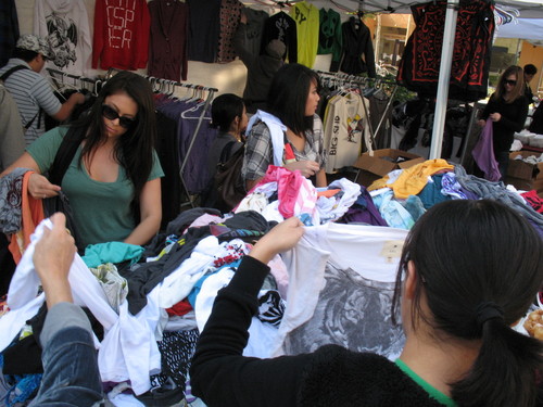 Students looking at clothing at vendor booths; photograph at University of California, Irvine