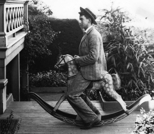 Young man on rocking horse