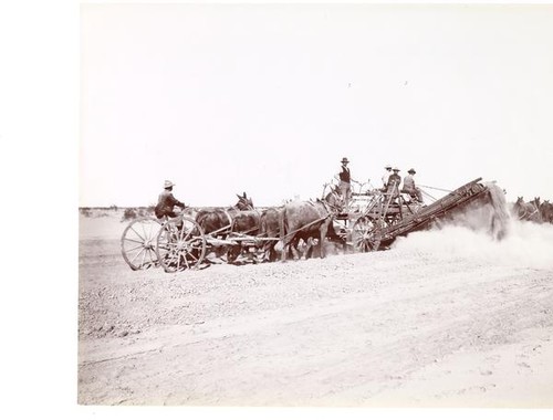 Men and team of horses operating a canal digging machine