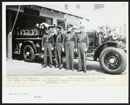 Firefighters stand alongside fire engine in front of Station No. 2, 526 East Anaheim Street