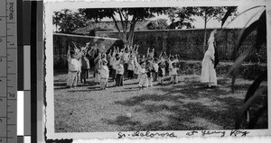 Children exercising with Maryknoll Sister, Yeung Kong, China, ca. 1930