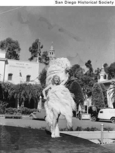 Sally Rand posing with her fans outside the Palace of International Art during the 1936 Exposition